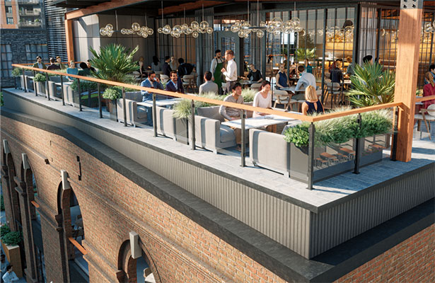 People enjoy rooftop restaurant and lounge area with tables and chairs