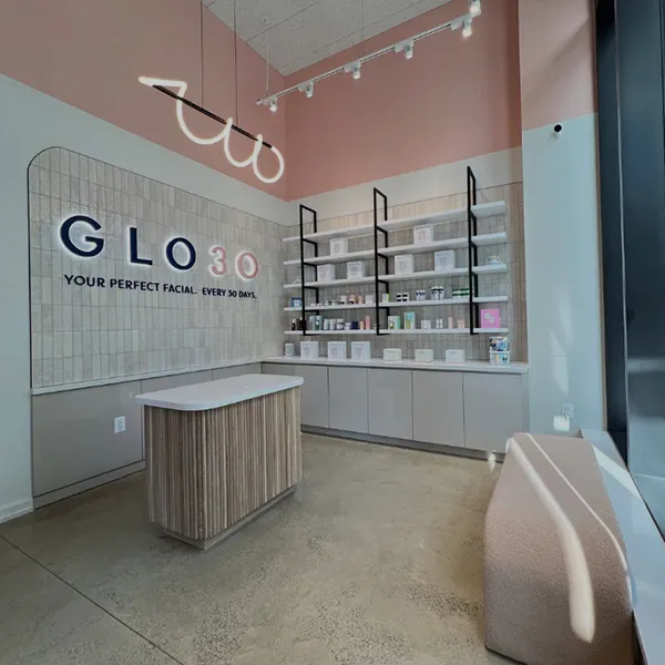 GLO30 skincare studio interior with modern design, product display shelves, and consultation counter