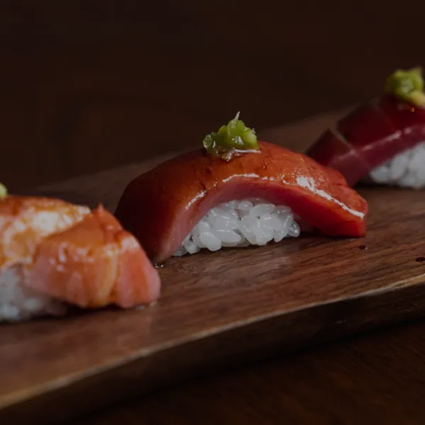 Fresh sushi nigiri with tender slices of tuna and salmon, topped with wasabi garnish