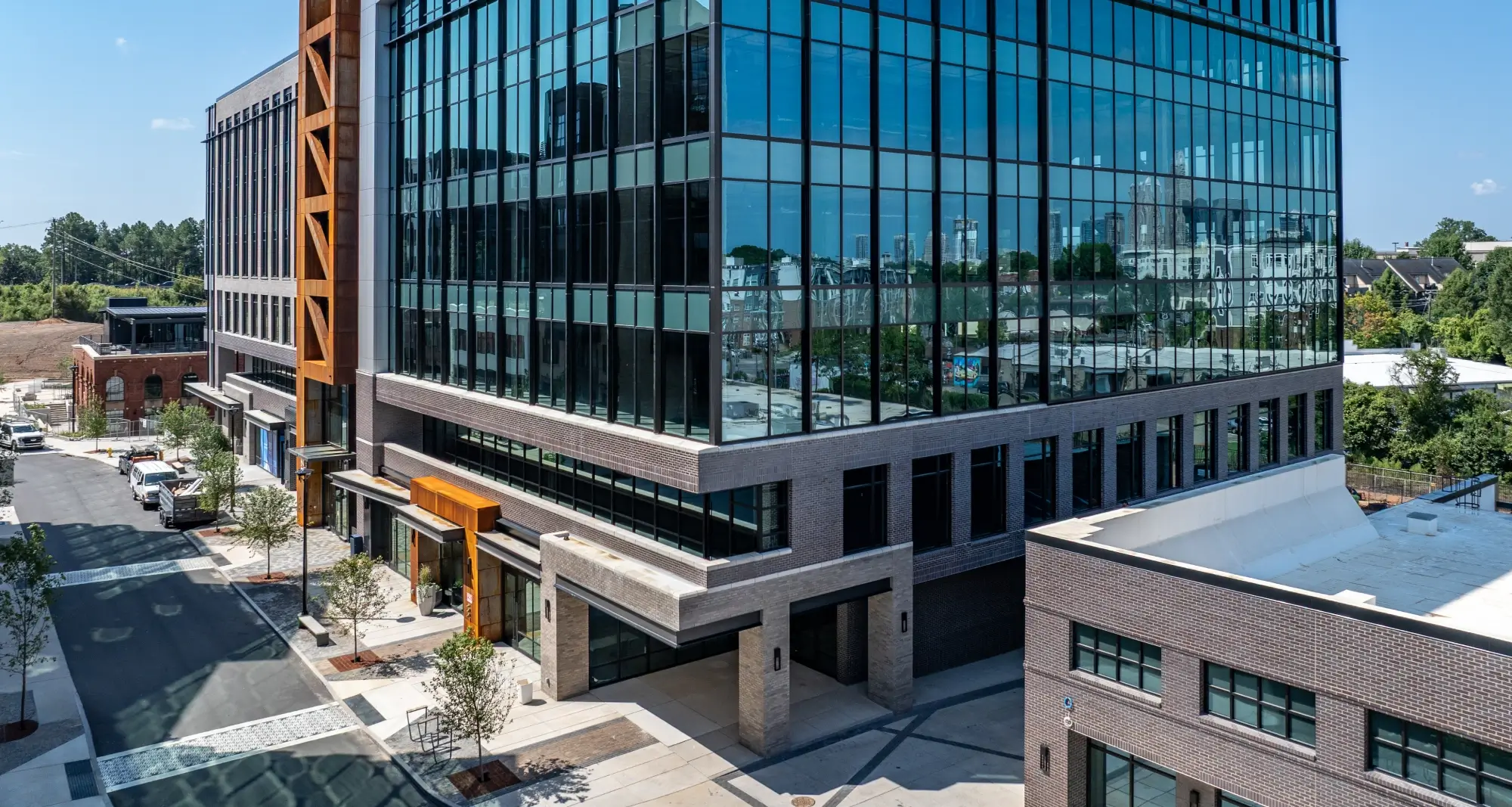 Aerial view of commercial building with contemporary finishes and nearby residential structures